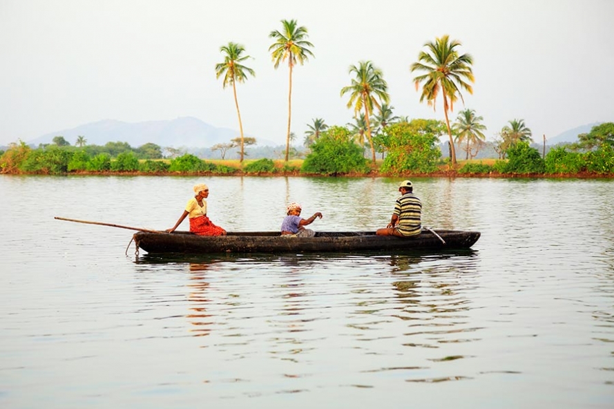 local goan family fishing in a canoe on the river sal near Cavelossim in Goa