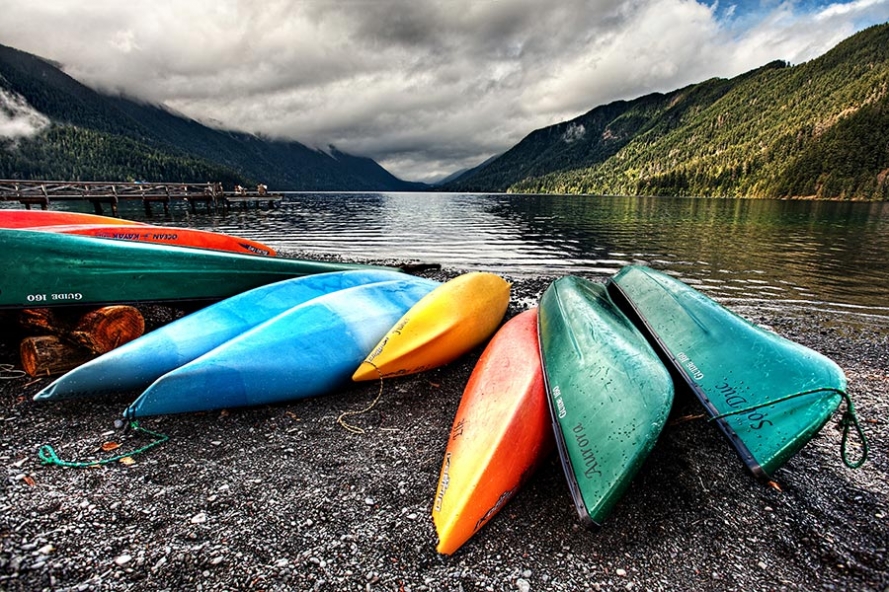 lake crescent with kayaks on the shore in the foreground
