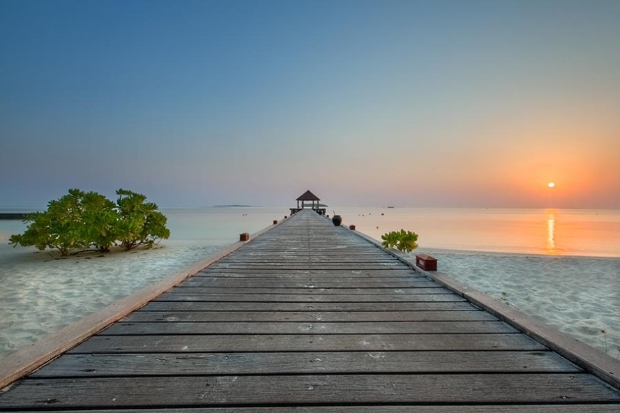 sunrise at the jetty on the island of komandoo in the maldives