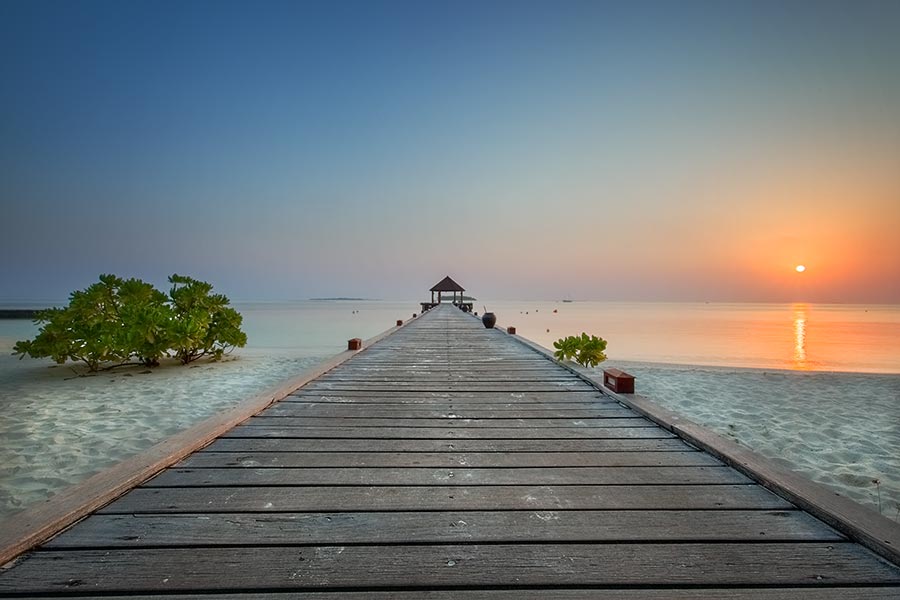 sunrise at the jetty on the island of komandoo in the maldives