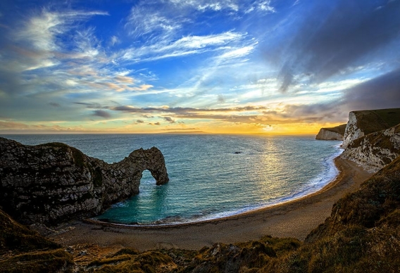 sunset at durdle door in dorset, uk