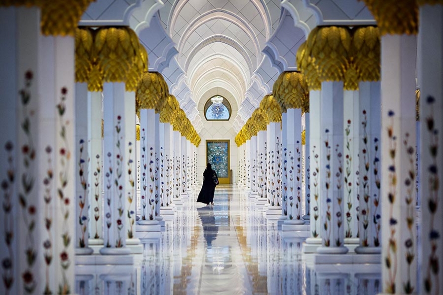 woman walking at sheikh zayed grand mosque in aub dhabi